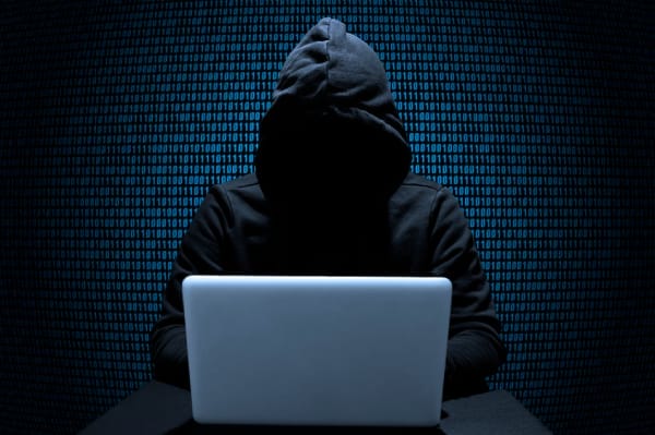Hacker attempting WiFi hack to steal data from unsecured networks
