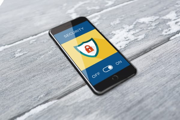 Mobile phone with security shield and lock symbol representing SEC client cybersecurity protection