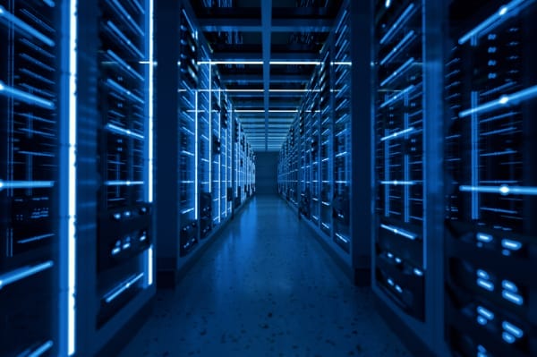 Rows of illuminated server racks in a secure data center, symbolizing the infrastructure behind website hosting and the importance of securing server environments to prevent hacks.