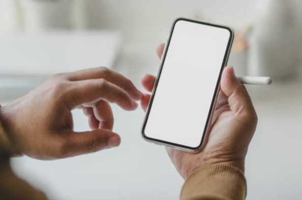 Close-up of hands holding a smartphone—representing mobile device considerations in endpoint security and cost planning for CMMC compliance